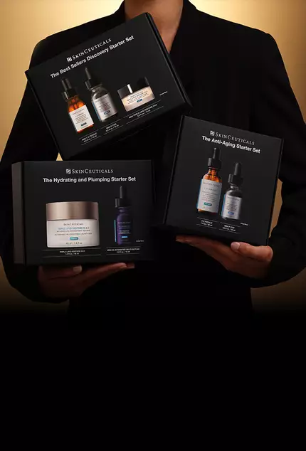 Person holding three boxes of products in starter set bundles